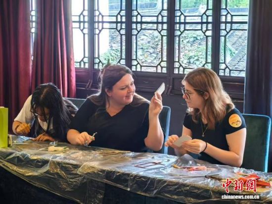 留学生们动手制作织锦书签。 中新网记者 钟升 摄 留学生们动手制作织锦书签。 中新网记者 钟升 摄