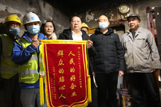1月13日,家住南京中央门街道铁路南街棚户区的老人王淑珍向中建三局一公司赠送锦旗。