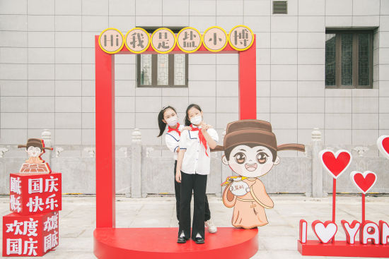 学生与“盐小博”互动拍照。